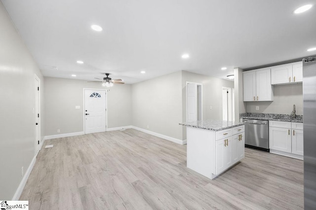 kitchen featuring a center island, white cabinets, light hardwood / wood-style flooring, ceiling fan, and appliances with stainless steel finishes