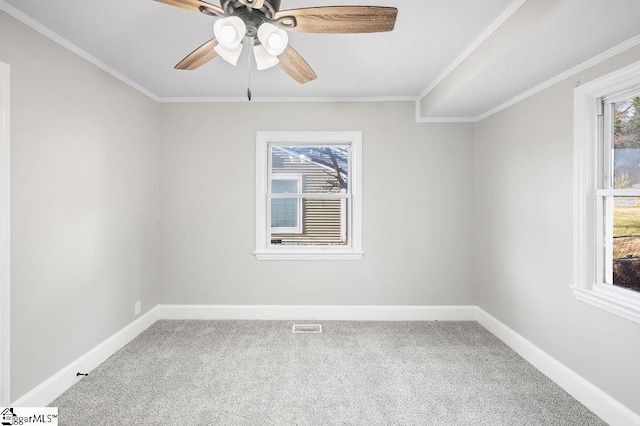 empty room with carpet flooring, ceiling fan, and ornamental molding