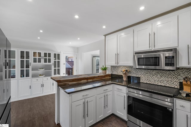 kitchen featuring kitchen peninsula, appliances with stainless steel finishes, and white cabinets