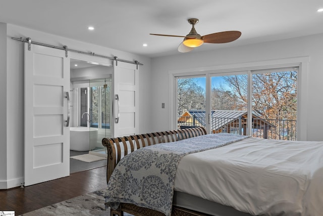 bedroom featuring access to exterior, a barn door, dark hardwood / wood-style floors, and ceiling fan