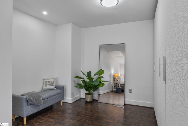 sitting room with dark wood-type flooring