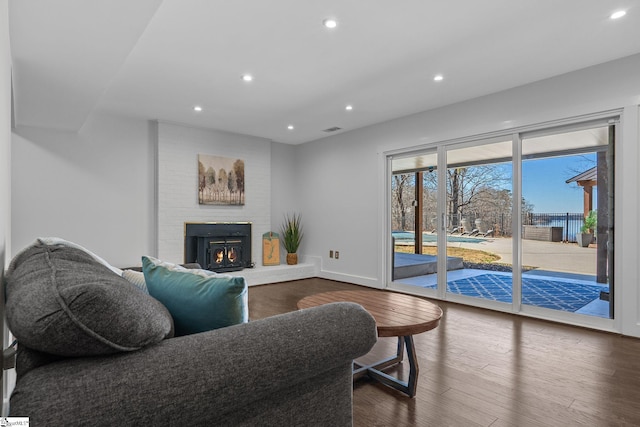 living room featuring a fireplace and dark hardwood / wood-style flooring