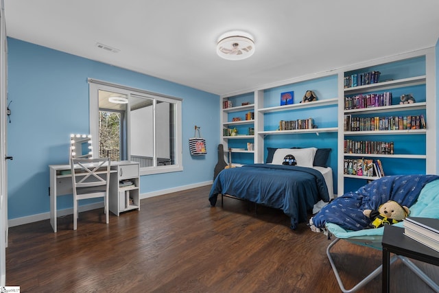 bedroom with dark hardwood / wood-style flooring