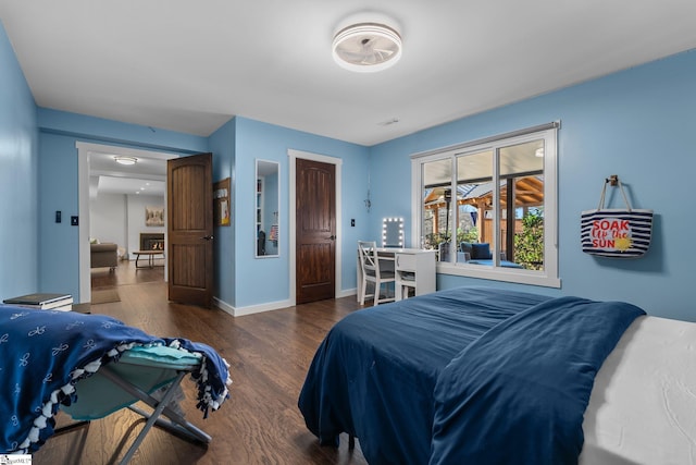 bedroom with dark hardwood / wood-style floors