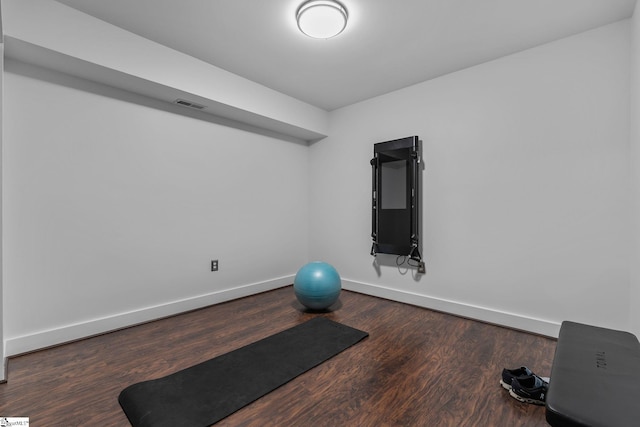 workout room featuring dark wood-type flooring