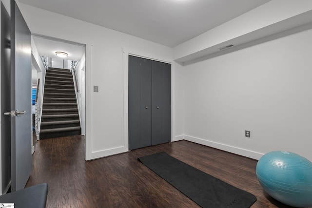 workout room with dark hardwood / wood-style floors