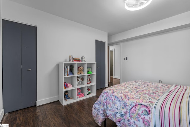 bedroom with dark hardwood / wood-style floors