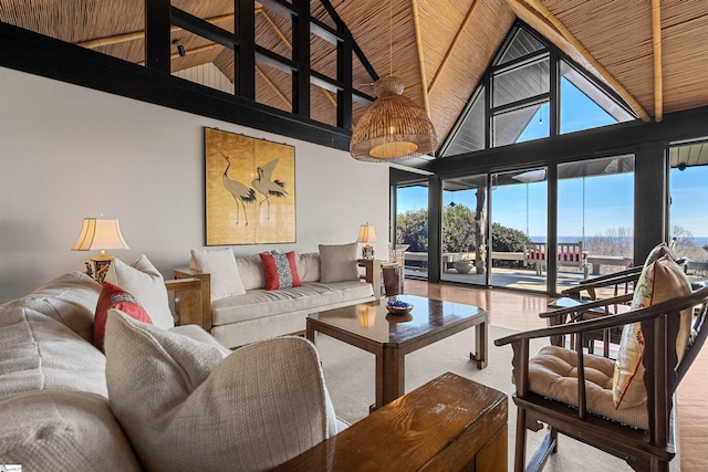 living room featuring beamed ceiling, wood-type flooring, high vaulted ceiling, and wooden ceiling