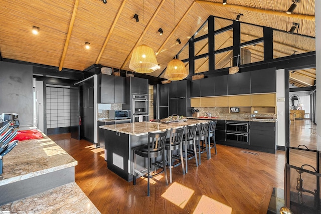 kitchen with a kitchen island, dark hardwood / wood-style floors, decorative light fixtures, wood ceiling, and stainless steel appliances