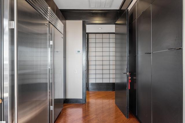 hallway with hardwood / wood-style floors