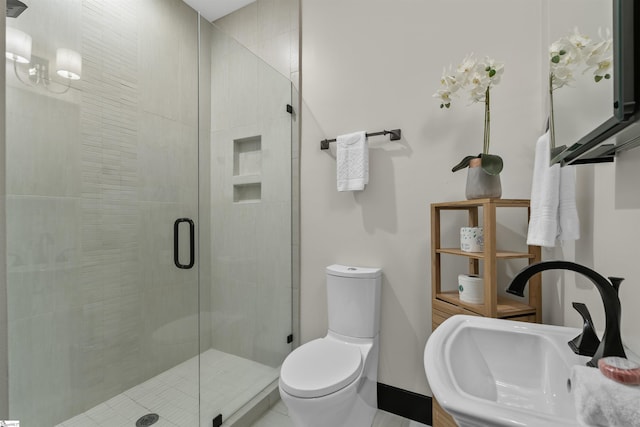 bathroom with sink, an enclosed shower, and toilet