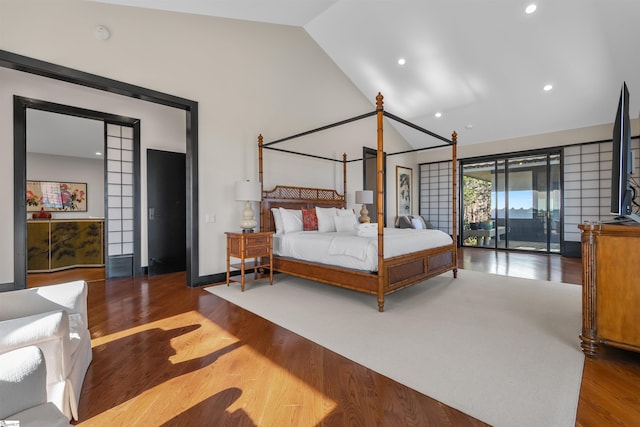 bedroom featuring wood-type flooring and vaulted ceiling