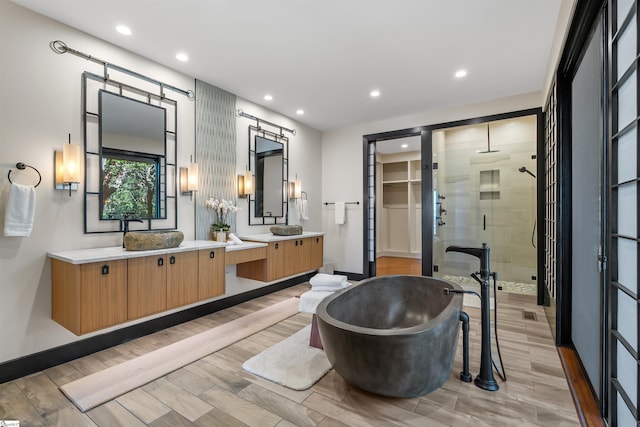 bathroom with vanity, hardwood / wood-style floors, and independent shower and bath