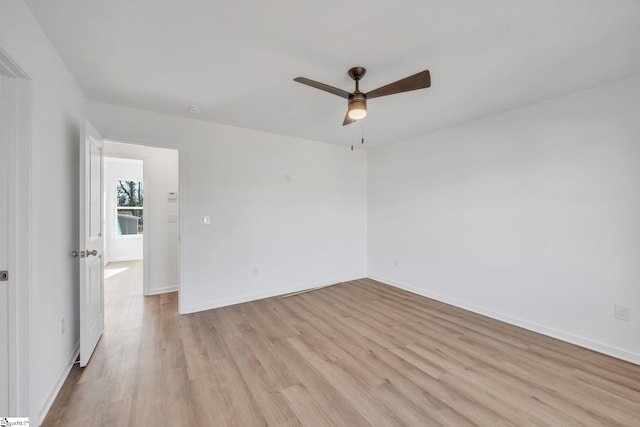 empty room with ceiling fan and light hardwood / wood-style floors