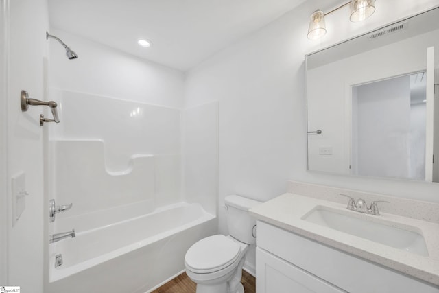 full bathroom featuring bathing tub / shower combination, vanity, and toilet