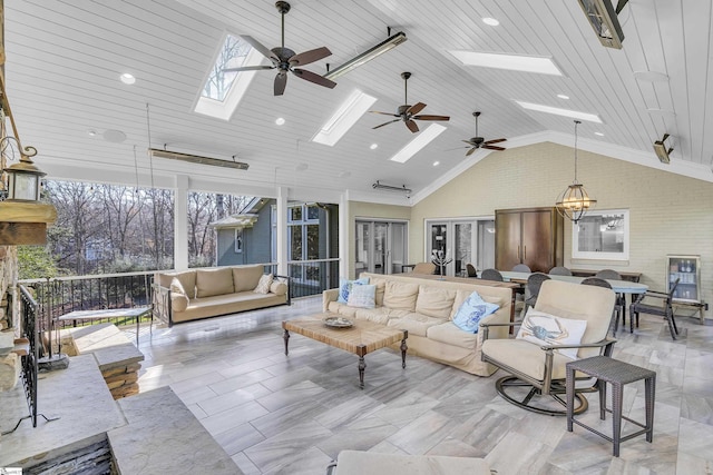 living room with lofted ceiling with skylight, wooden ceiling, and ceiling fan with notable chandelier