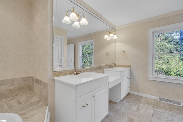 bathroom with a chandelier, vanity, and ornamental molding