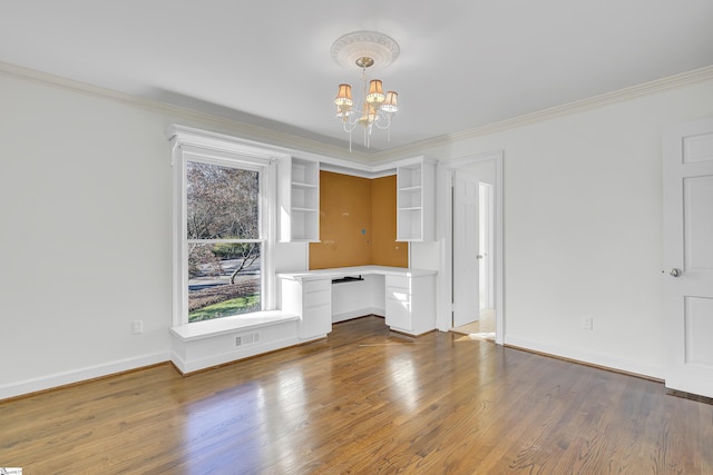 interior space with crown molding, wood-type flooring, and an inviting chandelier