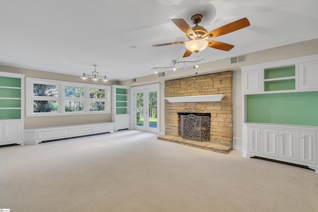 unfurnished living room with light carpet, a stone fireplace, and ceiling fan