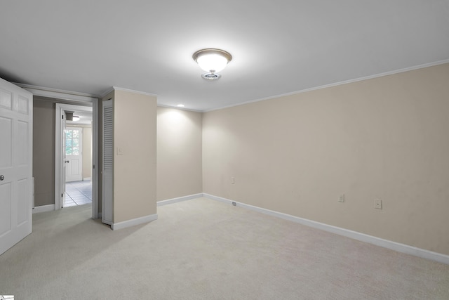 unfurnished room featuring light carpet and crown molding