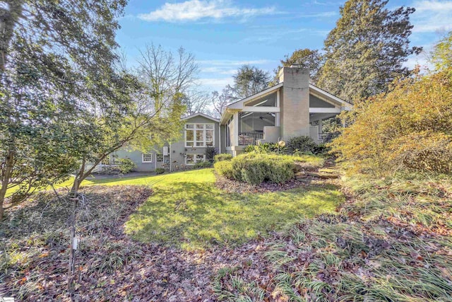 exterior space featuring ceiling fan and a lawn