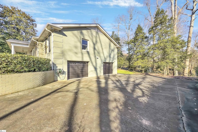 view of side of home featuring a garage