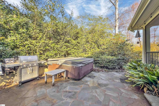 view of patio with area for grilling, exterior kitchen, and a hot tub