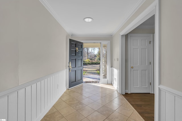 entrance foyer with light tile patterned floors and ornamental molding