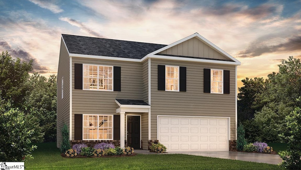 view of front of home with a lawn and a garage