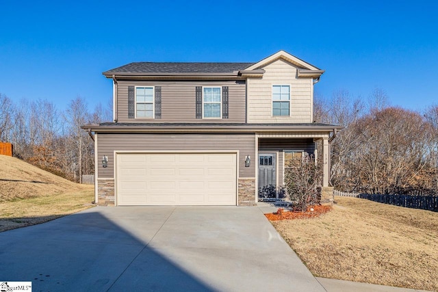 view of property with a garage and a front yard