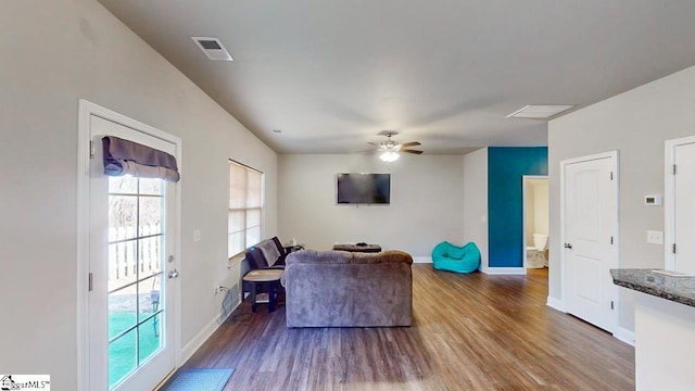 living room featuring hardwood / wood-style flooring and ceiling fan