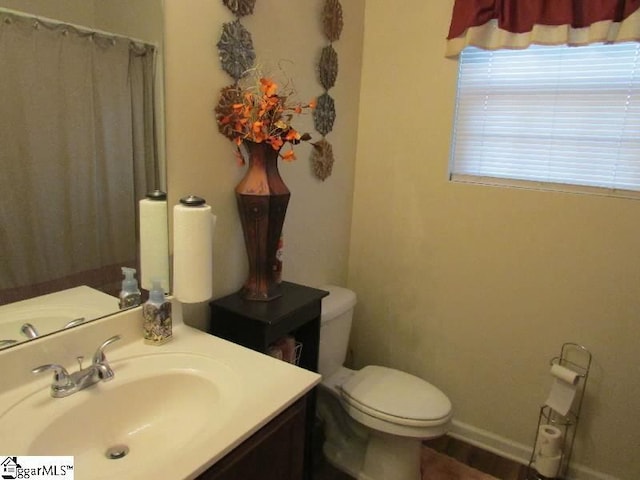 bathroom with vanity, toilet, and walk in shower