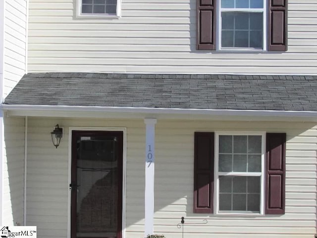 view of exterior entry with a porch