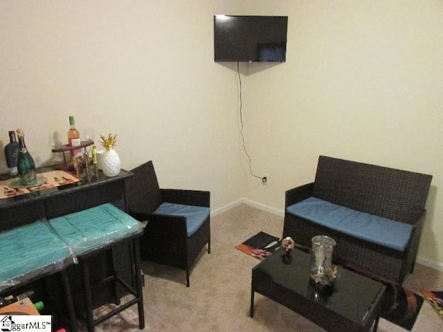 sitting room featuring light colored carpet