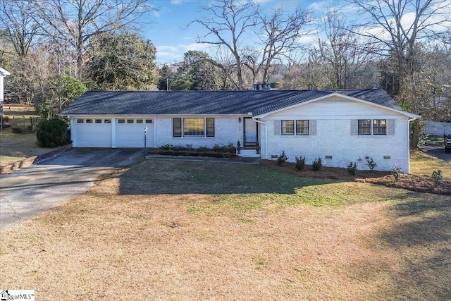 ranch-style house featuring a front yard and a garage