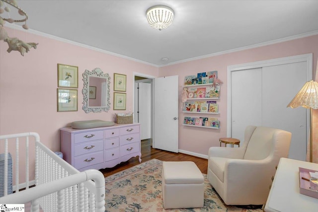 bedroom with wood-type flooring, ornamental molding, and a closet