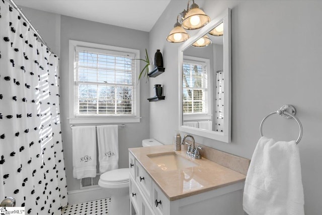 bathroom with a shower with shower curtain, vanity, and plenty of natural light