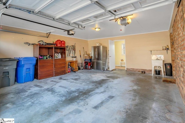 garage with stainless steel fridge and a garage door opener