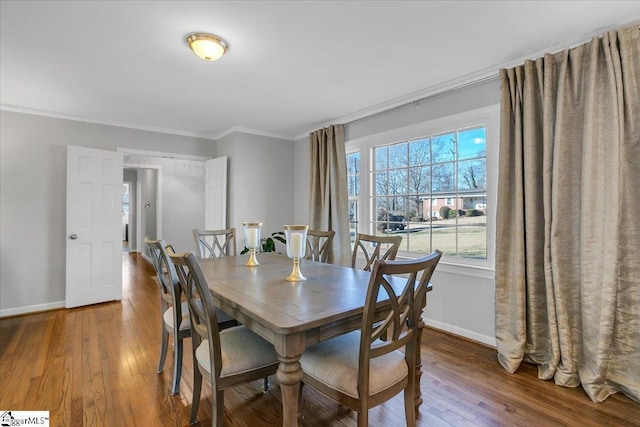 dining area with hardwood / wood-style floors and ornamental molding