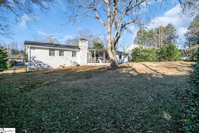 rear view of house with a lawn