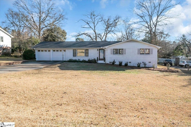 view of front facade with a garage and a front lawn