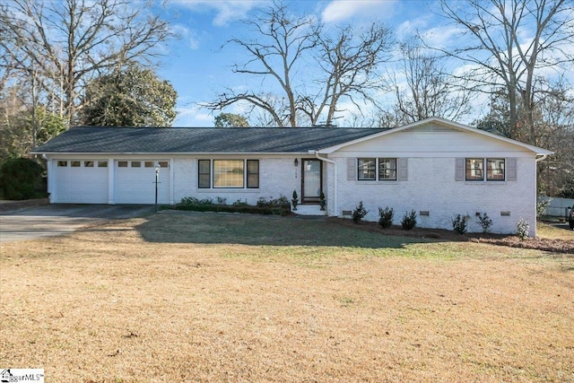 ranch-style home with a front yard and a garage