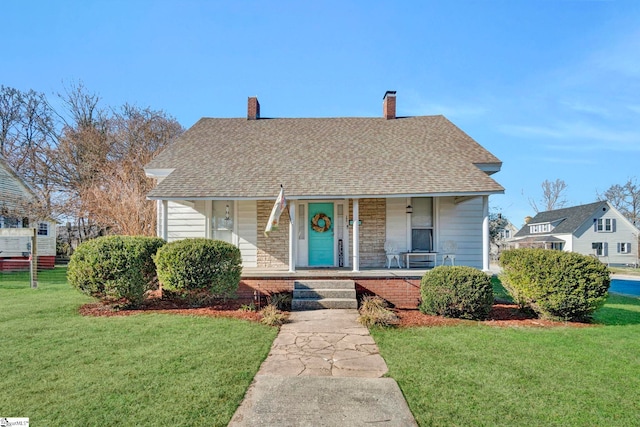 bungalow-style house featuring covered porch and a front lawn