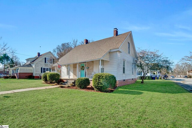 view of front of home featuring covered porch and a front lawn