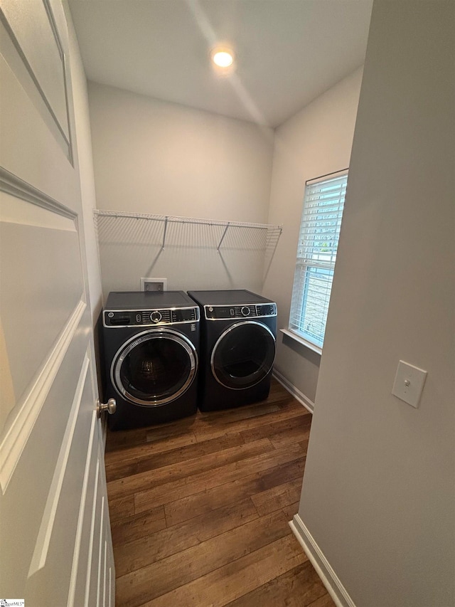 laundry area featuring washer and clothes dryer and dark hardwood / wood-style floors