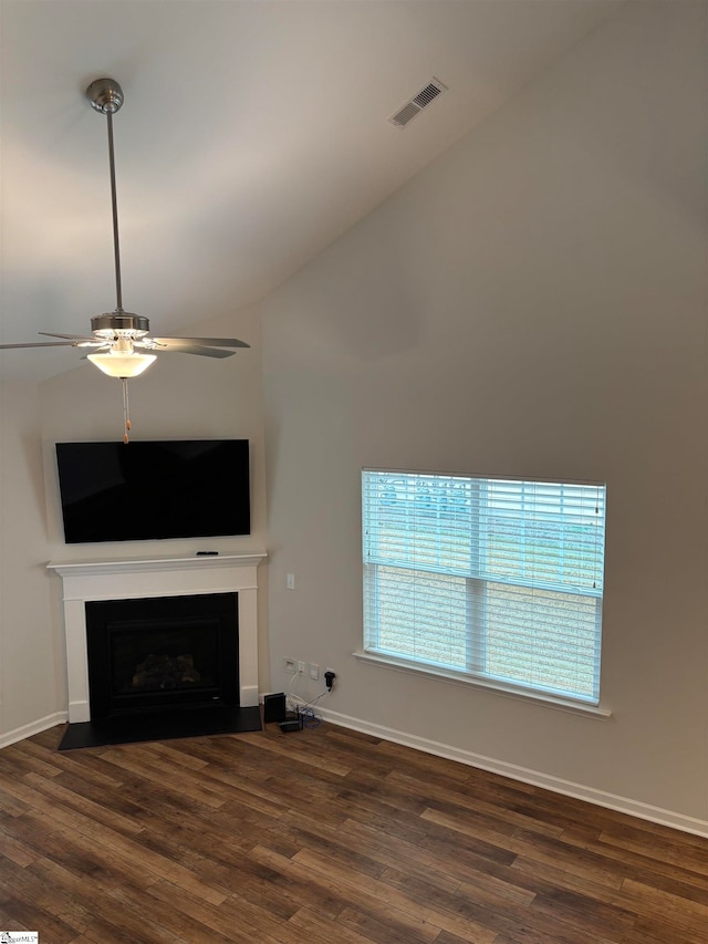 unfurnished living room featuring dark hardwood / wood-style floors, vaulted ceiling, and ceiling fan