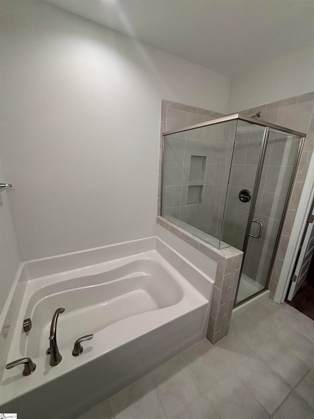 bathroom featuring tile patterned floors and separate shower and tub