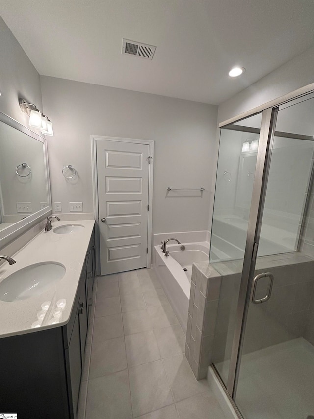 bathroom with tile patterned flooring, vanity, and independent shower and bath