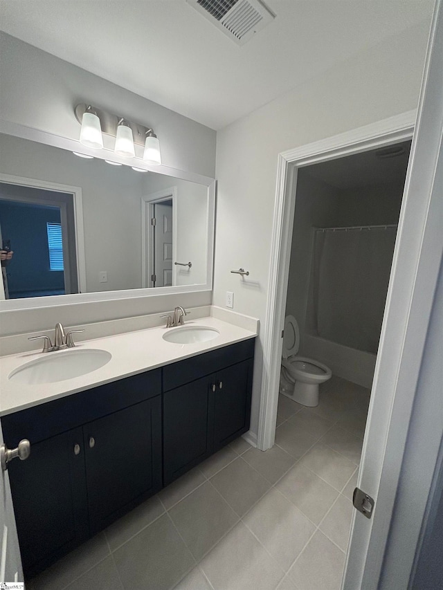 bathroom with tile patterned floors, a shower with curtain, vanity, and toilet