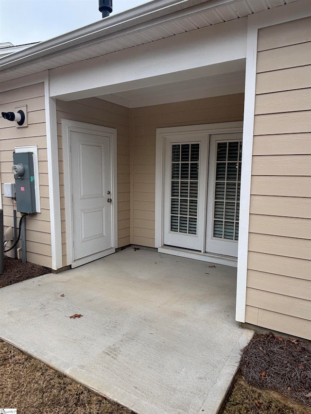 view of exterior entry featuring a patio area